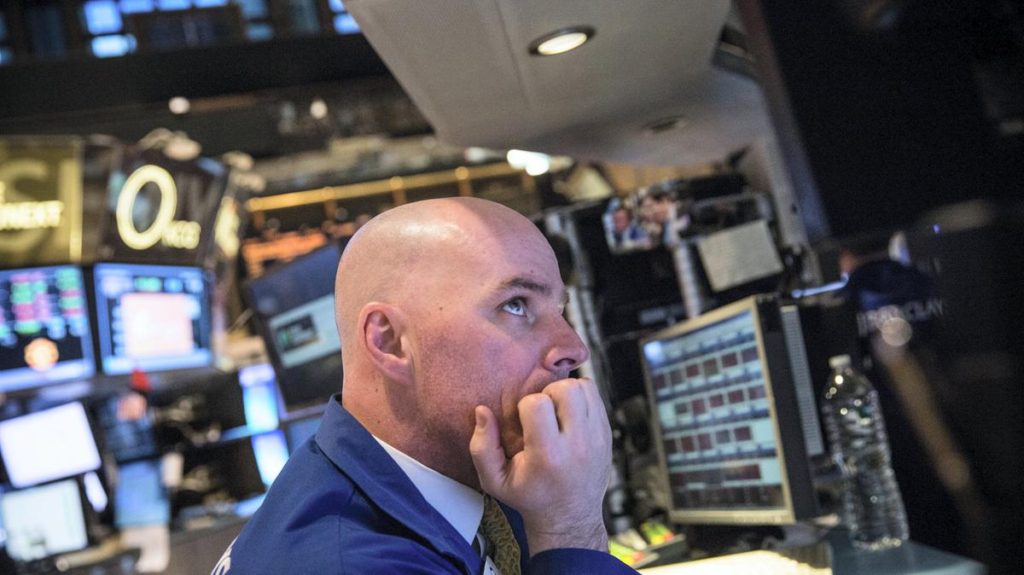 Modern US stock market trader working with multiple screens